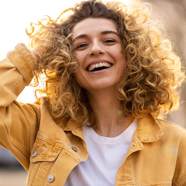 curly haired lady smiling