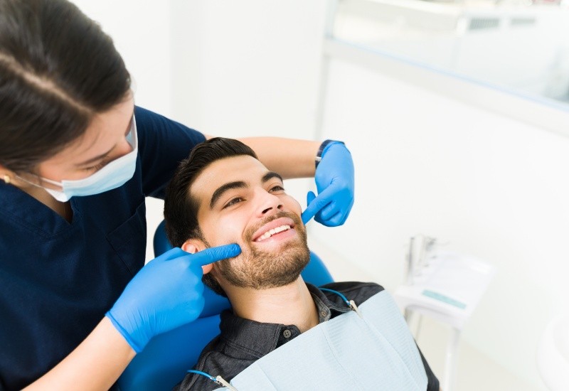 Dentist Performing a Preventive Dental Exam on a Patient Seated in a Dental Chair in Brecksville, OH